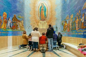 Family praying in Our Lady of Guadalupe Chapel