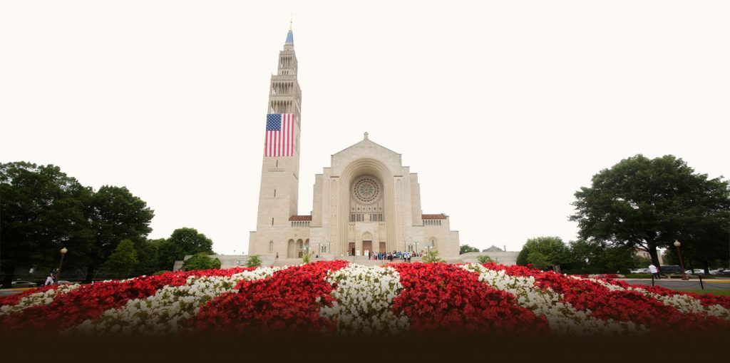 basilica front exterior with red and white flowers