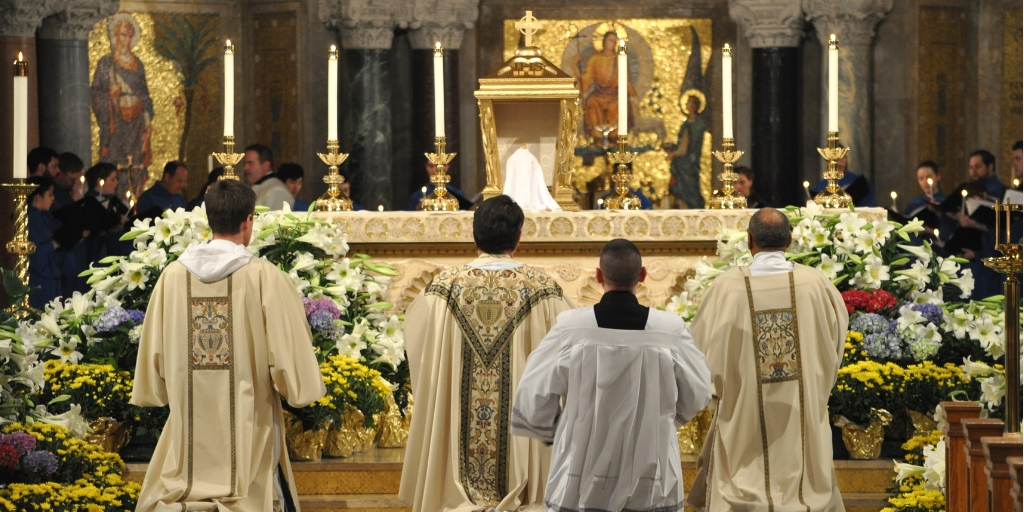 Kneeling before altar at Holy Thursday Mass