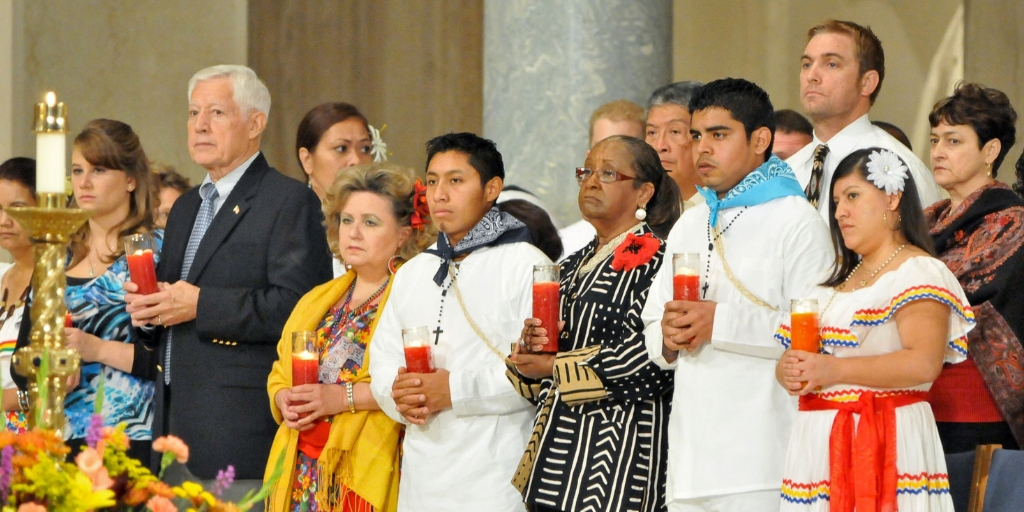 Pilgrims hold candles during service