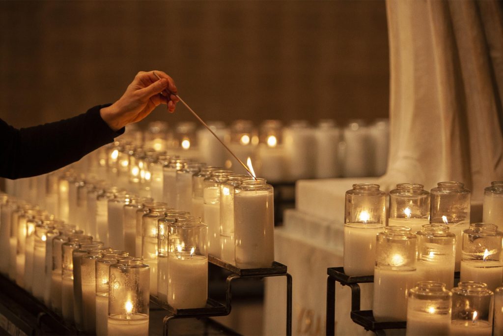 basilica visitor lights candle