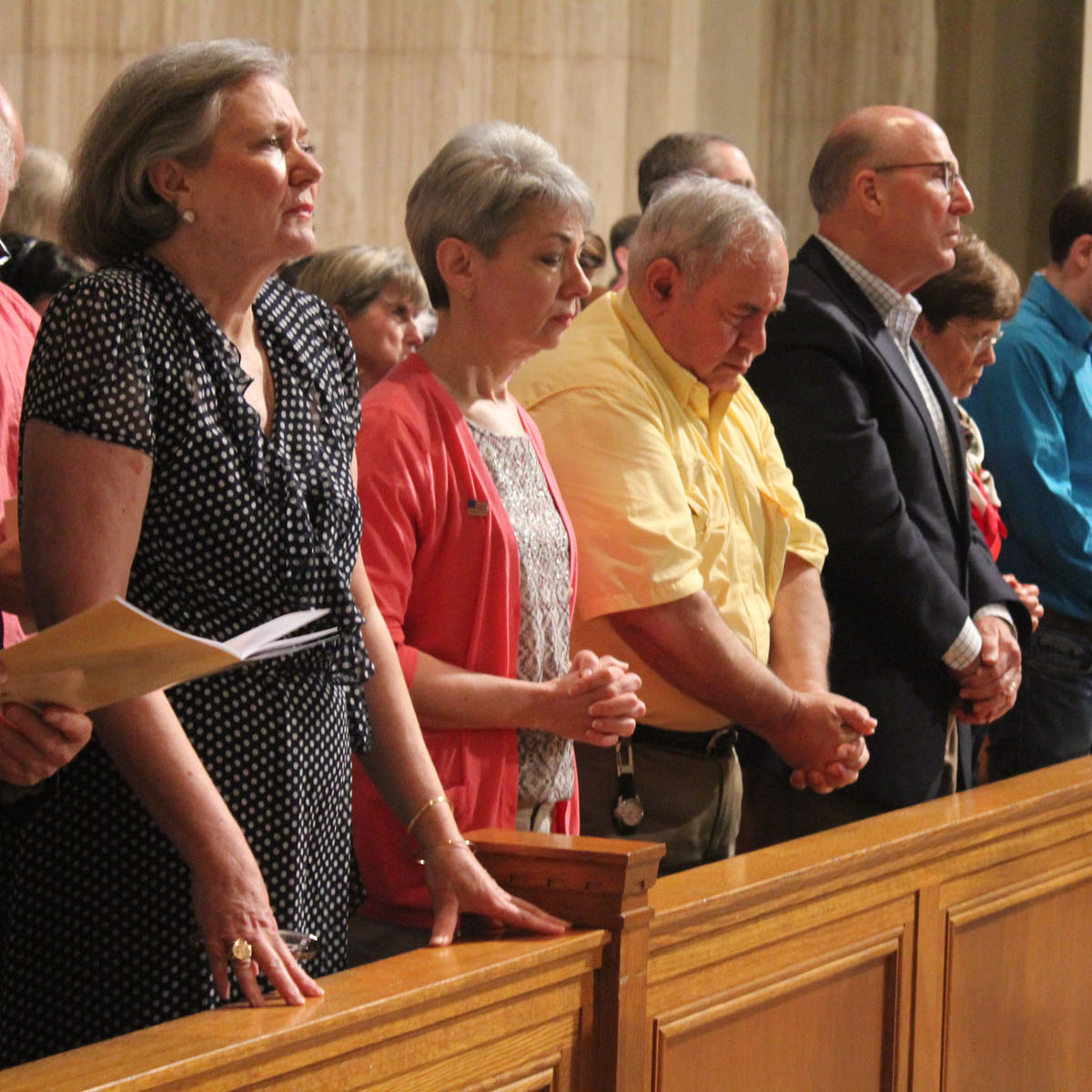 Congregation stands in Mass 