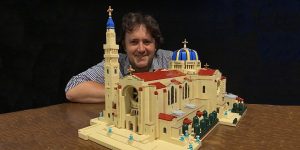 Artist John Davisson shown with his LEGO model of the Basilica