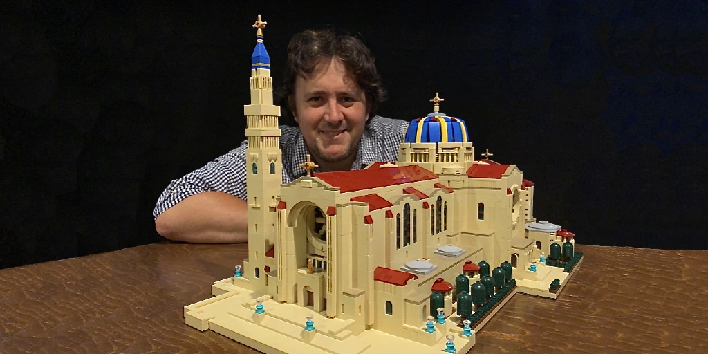Artist John Davisson shown with his LEGO model of the Basilica