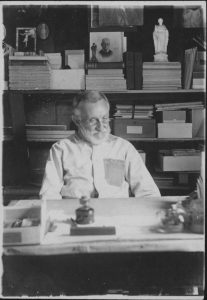 Joseph Dutton at his desk in Molokai