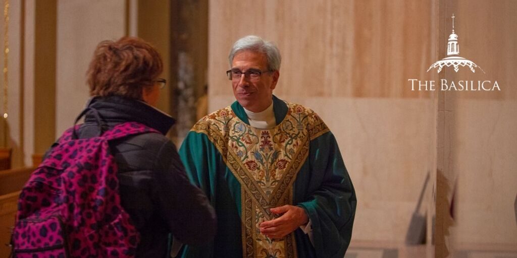 Monsignor Vito handshake banner