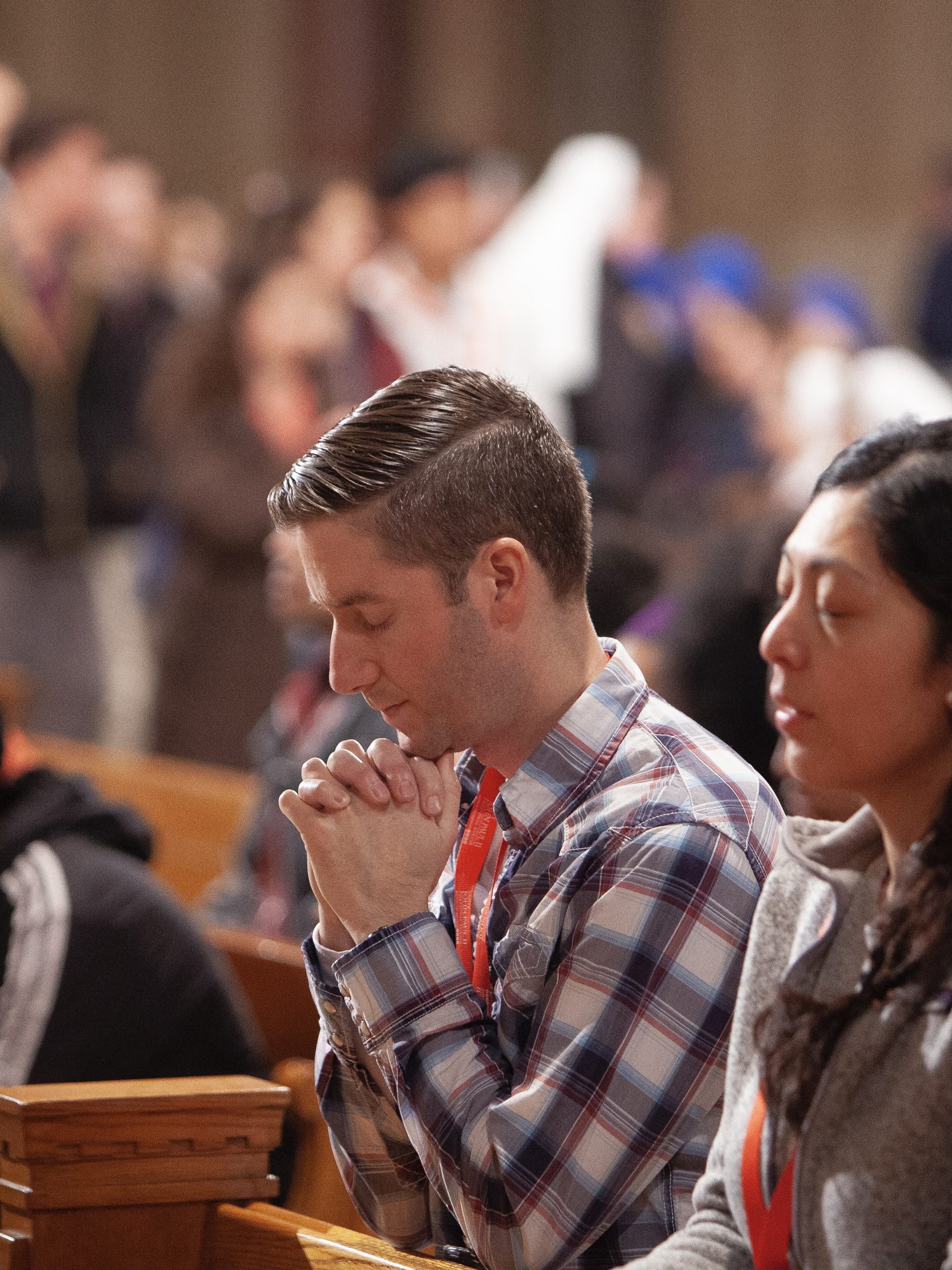 Man prays in the Upper Church of the Basilica during mass