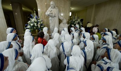 Missionaries of Charity Surround Statue of Mother Teresa