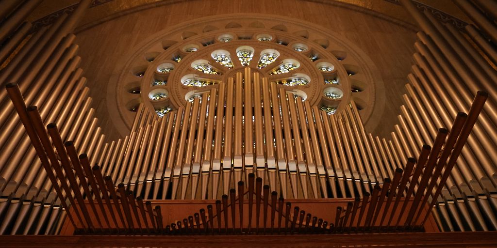 The pipes of the Great Upper Church organ with the Rose window in the background