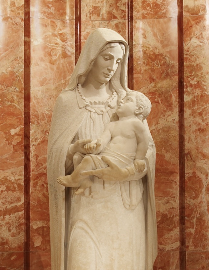 A statue of Mary holding Jesus in the Our Mother of Divine Providence oratory