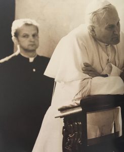 Pope John Paul II kneels in prayer at the Basilica
