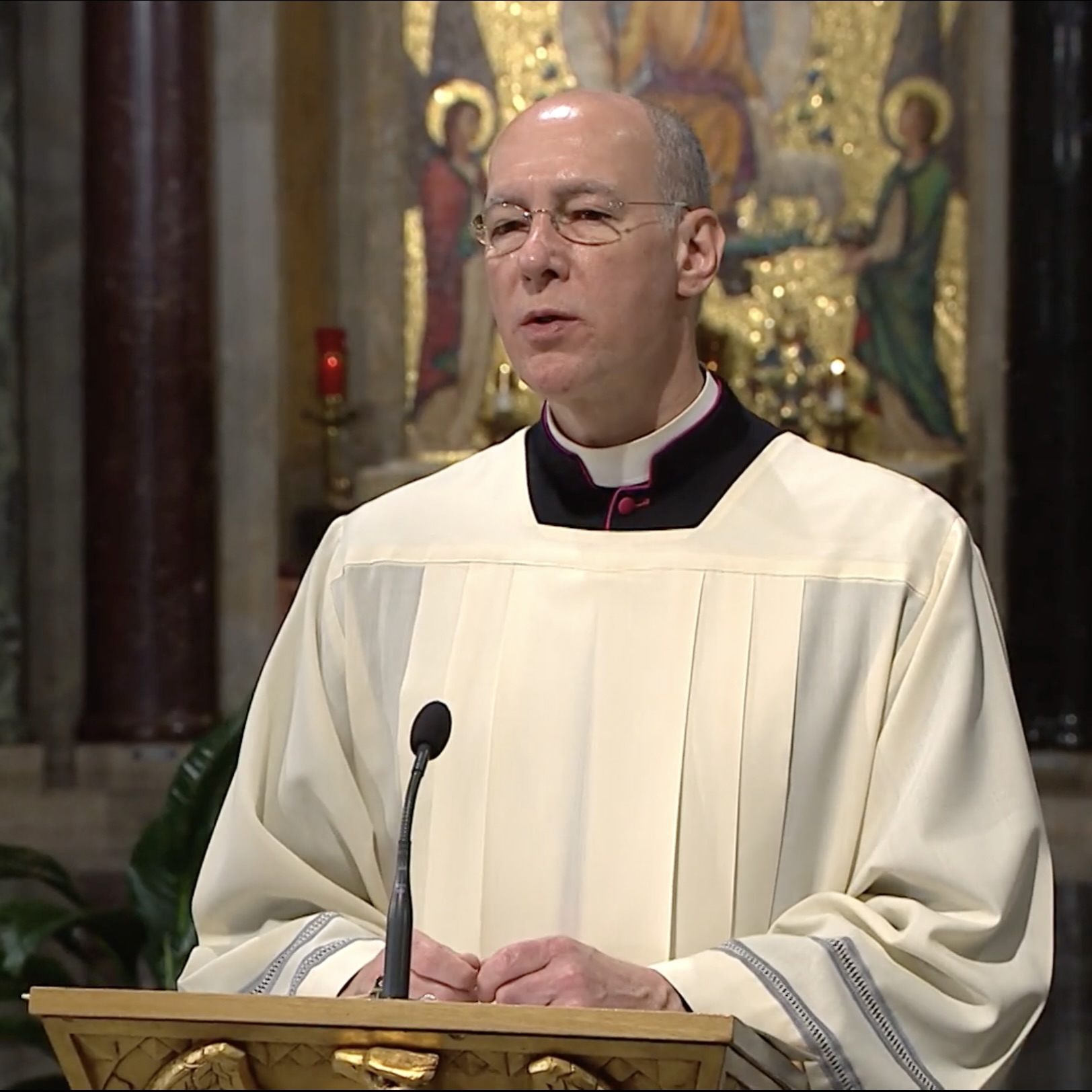 Msgr. Rossi speaks in the Crypt Church
