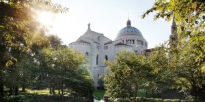 The exterior of the National Shrine in daylight, trees in the foreground