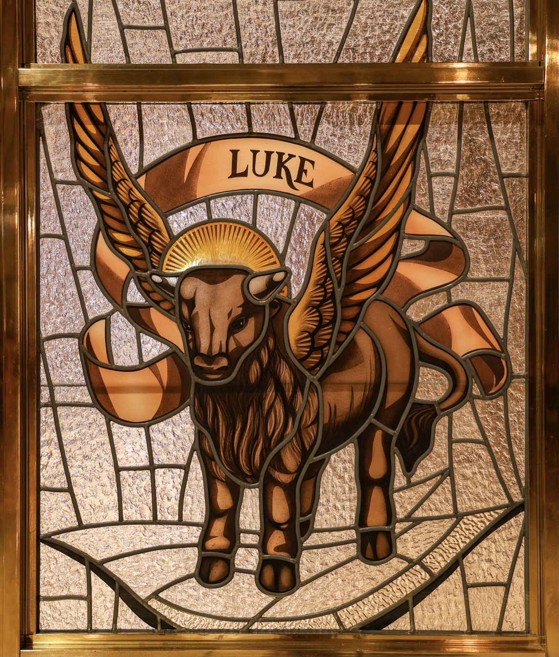 The symbol of St. Luke portrayed in the Crypt Church Sacristy Doors