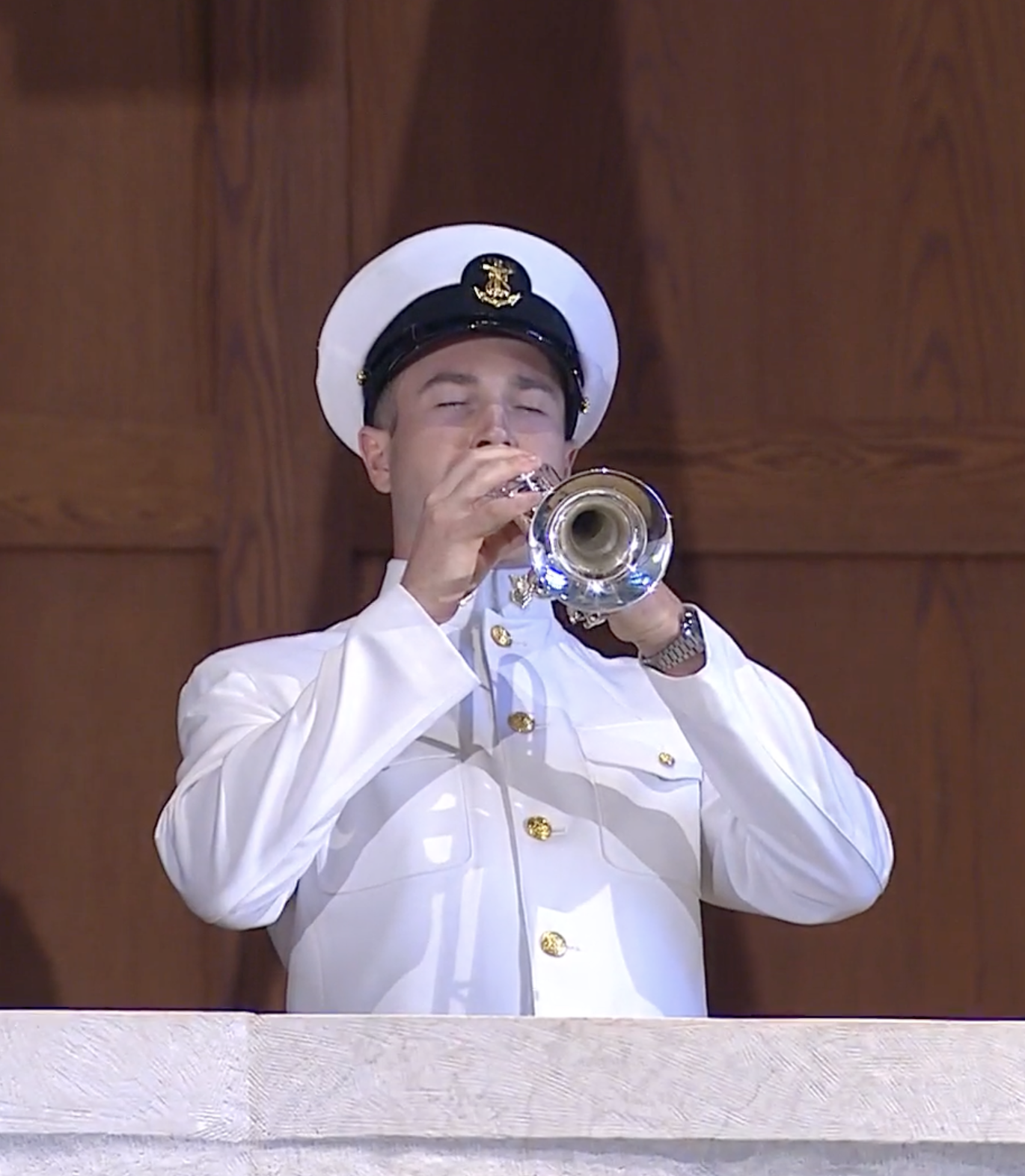 A service member plays Taps at the 2026 Memorial Mass