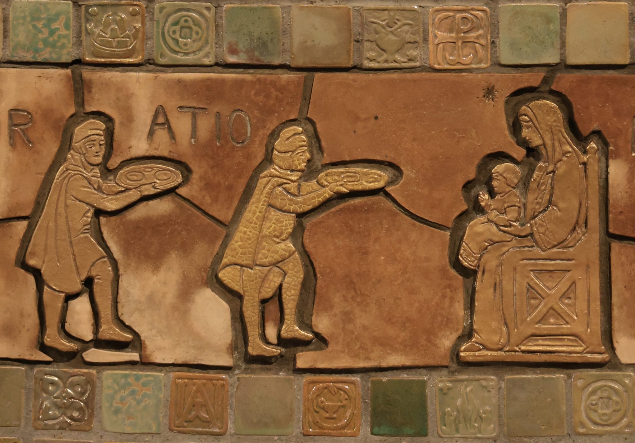 Tile art shows the magi bringing gifts to the infant Jesus as he sits on Mary's lap