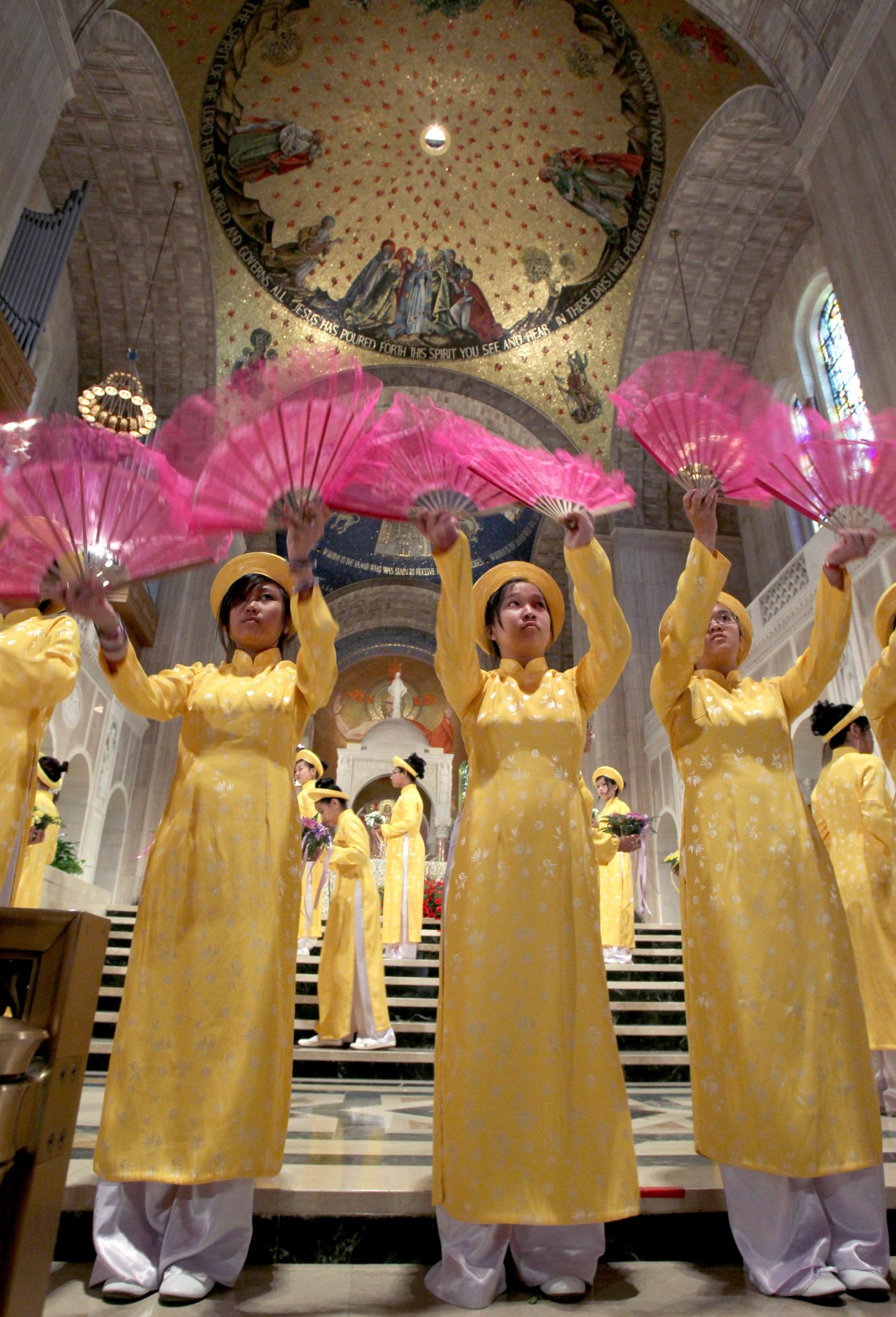Girls from Vietnam dance with fans at Basilica
